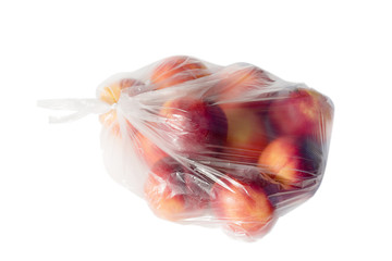 Peaches in plastic bag isolated on white.