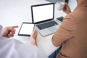 Teamwork process, Business team managers colleagues discussing and analysis new project investment plan, strategy in business profit, marketing documents report on table with laptop and tablet