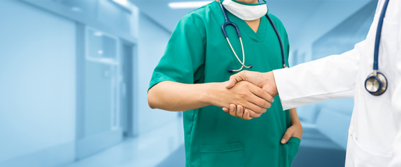 Doctors shaking hands. Medical people teamwork.