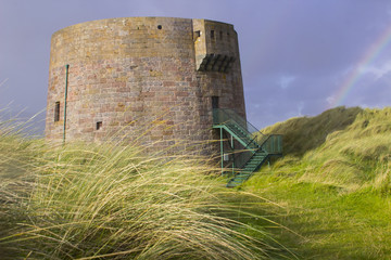 Fototapeta na wymiar The 19th century round Martello tower fort built in the sand dunes at Magilligan Point near Limavady in County Derry in Northern Ireland