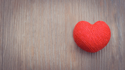 Creative red cotton heart on the wooden background. Top view. Valentine`s day background. Copy space.