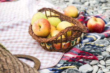 autumn picnic with apples,  pears and a basket for eating