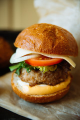Delicious fresh homemade burger on a wooden table