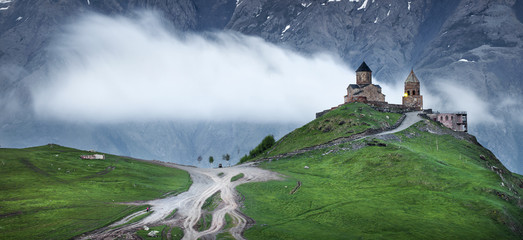 moving clouds behind old church in Georgia - obrazy, fototapety, plakaty