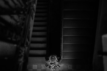beautiful blonde poses near old windows in a building