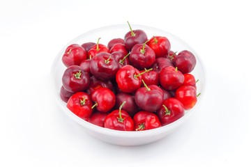red cherries in plastic bowl on white background