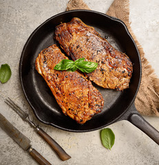 grilled steak and basil on a frying pan