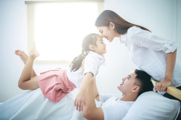 Fototapeta premium A happy asia family with kids in the living.