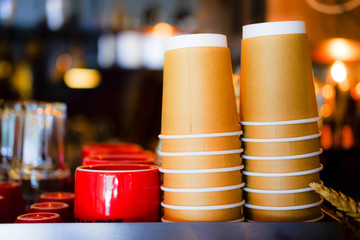 Red coffee cups and paper cups on coffee machine