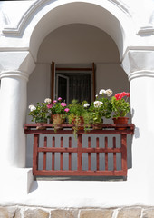 Fototapeta na wymiar Medieval wooden balcony with flowers
