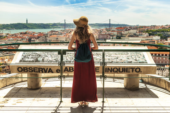 People in Lisbon - traveler on tour on city streets with panorama view