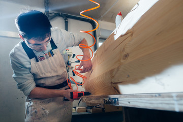 tattooed men with gun nails. carpenter work