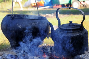 Boiling kettle and pot on the fire.