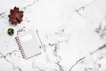 Marble table flat lay with gold stationary accessories, notebook and pen for bloggers, students, office