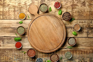 Foto auf Acrylglas Kräuter Composition with cutting board, spices and herbs on wooden background