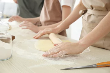 Tuinposter Koken Family preparing dough together in kitchen. Cooking classes concept