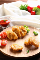 Tasty nuggets and gravy boat with sauce for chicken on table