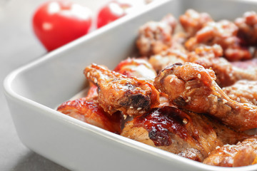 Tasty chicken with sauce in baking dish, closeup