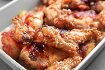Tasty chicken with sauce in baking dish, closeup