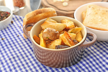 Baking dish with potatoes on table. Cooking for one concept