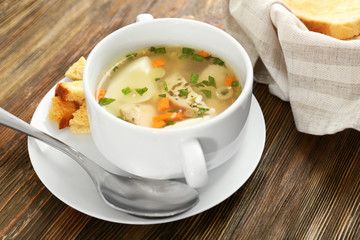 Plate with tasty soup on table. Cooking for one concept