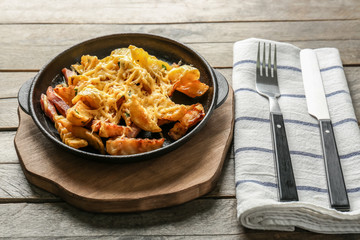 Baking dish with tasty dinner on table. Cooking for one concept