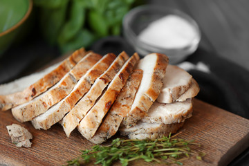 Delicious sliced turkey breast on wooden board