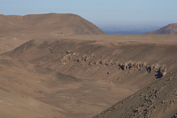 Dry river valley in the Atacama Desert of northern Chile running towards the Pacific Ocean.