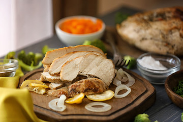 Delicious sliced turkey breast on wooden board