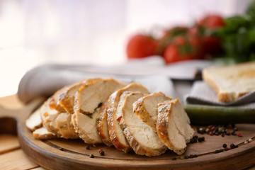 Delicious sliced turkey breast on wooden board