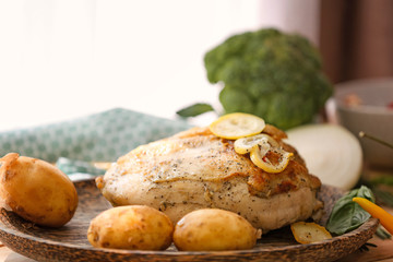 Delicious whole turkey breast on wooden plate