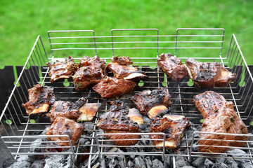Cooking of appetizing juicy spare ribs outdoors