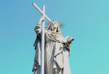 statue of Holy Virgin holds the cross in his hand.