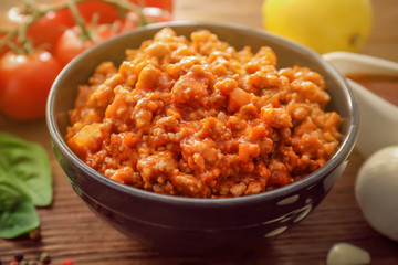 Meat sauce in ceramic bowl on kitchen table