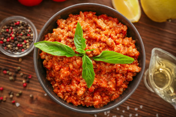 Meat sauce in ceramic bowl on kitchen table
