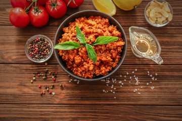 Meat sauce in ceramic bowl on kitchen table