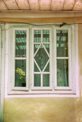 three wooden windows with green glasses