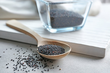 Black quinoa and wooden spoon on table