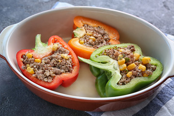 Quinoa stuffed peppers in casserole dish on kitchen table