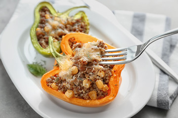Eating quinoa stuffed pepper, closeup