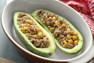 Quinoa stuffed zucchini in casserole dish on kitchen table