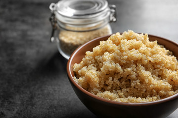 Bowl with boiled white quinoa grains on kitchen table