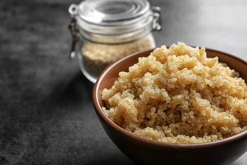 Rolgordijnen Bowl with boiled white quinoa grains on kitchen table © Africa Studio