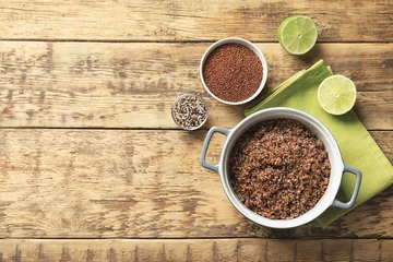 Gordijnen Pot with boiled quinoa grains on wooden table © Africa Studio