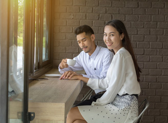 Asian young couple in love at a coffee shop
