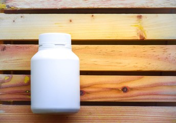 Bottle water made to plastic on the wood background.Using wallpaper for package or product, drug image and copy space.