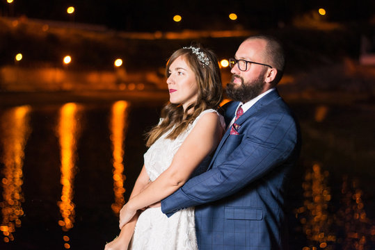 Wedding couple by the lake at night