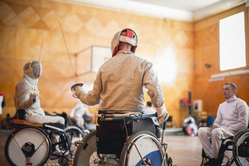 training disabled fencers sitting on a wheelchair