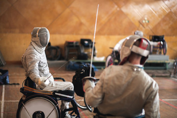 disabled fencers and their trainer at workout