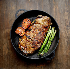 grilled steak and basil on a frying pan